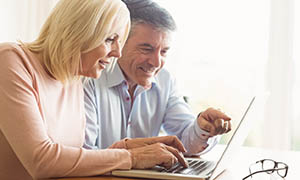 mature couple using laptop