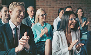 business audience clapping during presentation